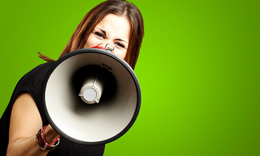 A woman shouting through a megaphone.