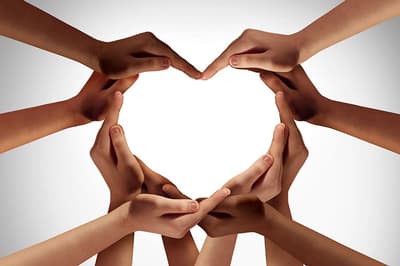 Ten cupped hands formign the outline of a heart shape