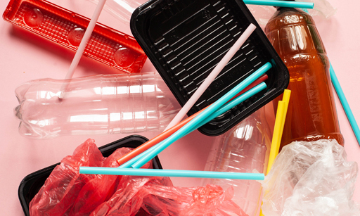Various plastic products, like straws, empty drinks bottles, and bags.