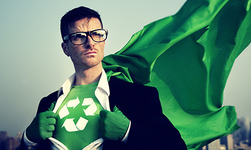 A geeky looking super hero wearing glasses, pulling his shirt apart to reveal a green super hero outfit with a recycling logo on the chest.